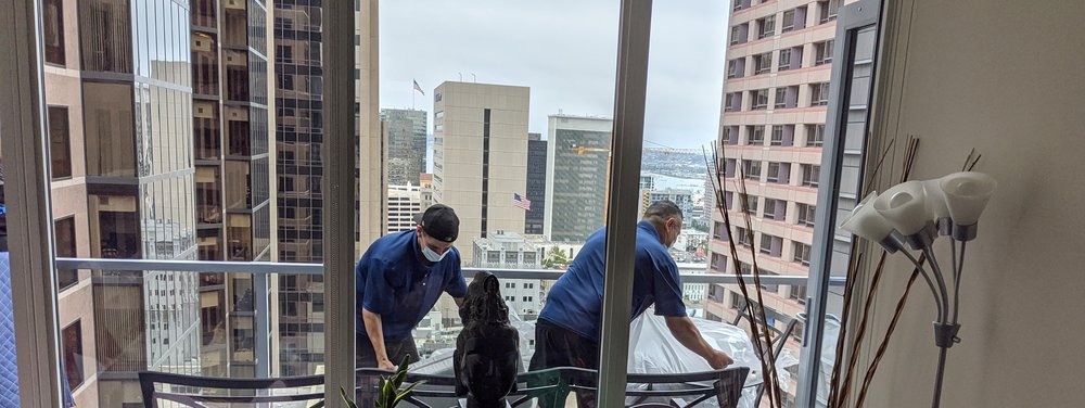 Crew carefully delivering furniture in a downtown San Diego high-rise