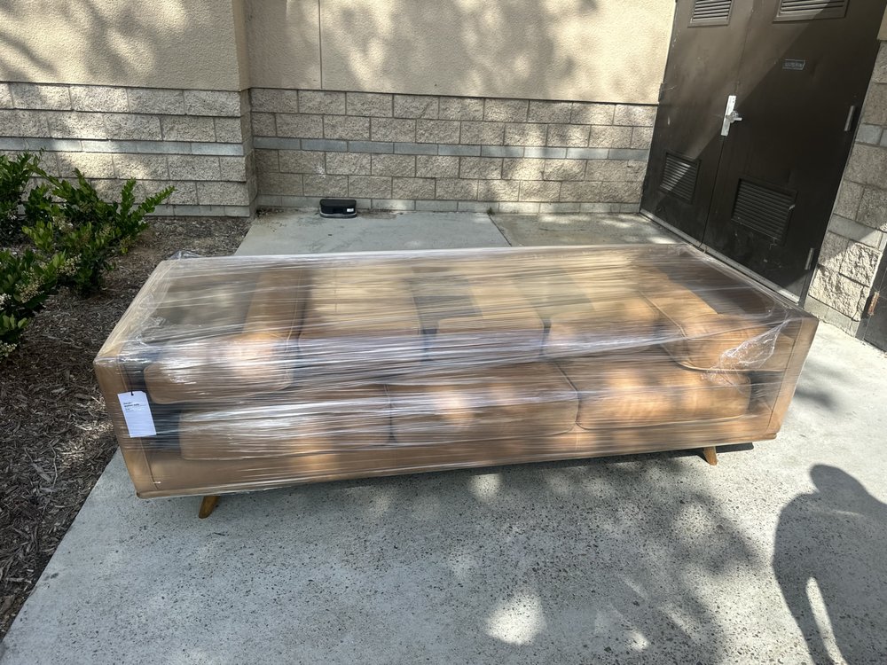 Wrapped sofa being delivered to a residential property